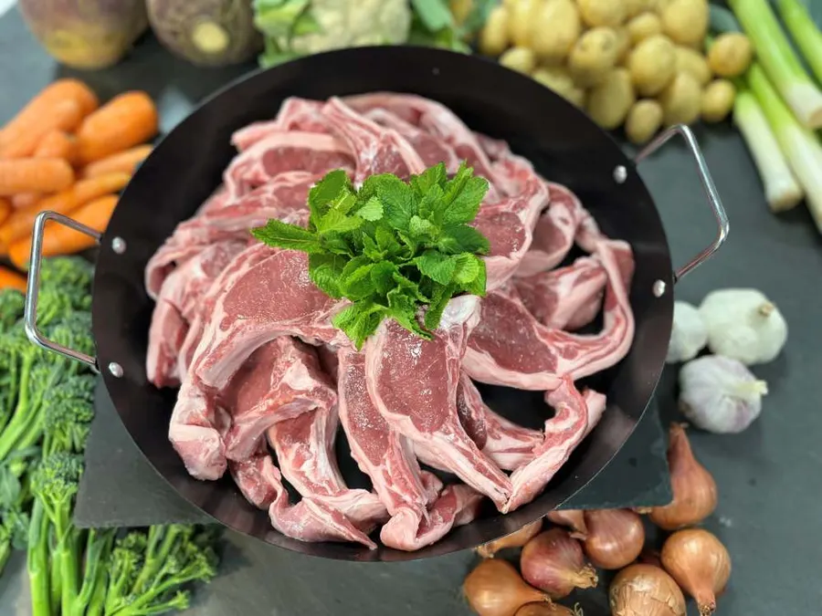 Pan of lamb ribeye chops with parsley